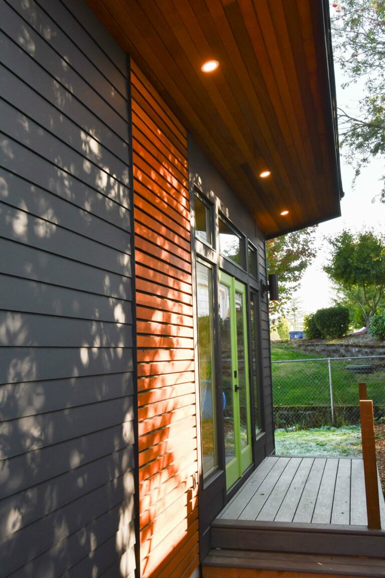 modern ADU with blue siding and cedar accents. shed style roof.