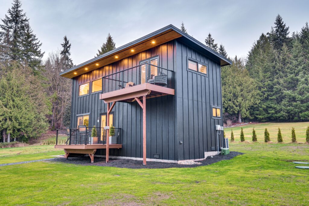 two story ADU with black siding and natural wood trim